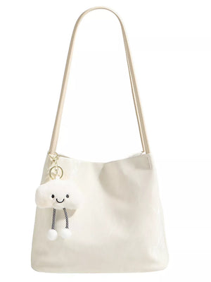 White pu leather shoulder bag with cute cloud charm and plush pom-poms.