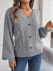 Grey cable knit button-front cardigan with V-neck and balloon sleeves.