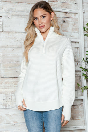White ribbed knit pullover sweater with funnel neck and quarter zip, long sleeves.