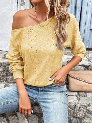 Yellow off-shoulder eyelet knit blouse with long sleeves and a diamond pattern.