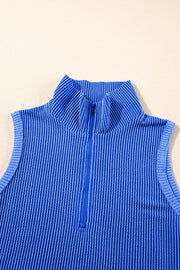 Royal blue ribbed polo top with a quarter zip and vertical stripe texture.