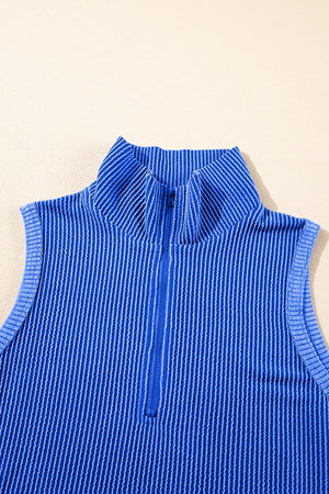 Royal blue ribbed polo top with a quarter zip and vertical stripe texture.