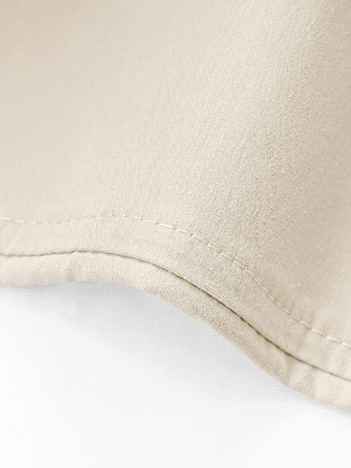 Beige cuffed hemline wide-leg trousers detail showing double stitching and fabric texture.