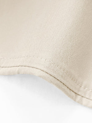 Beige cuffed hemline wide-leg trousers detail showing double stitching and fabric texture.