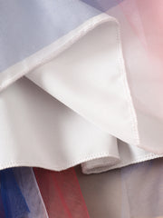 Patriotic star-spangled tulle dress with blue, white, and red layers and white lining.