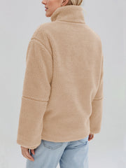 Tan sherpa stand-collar jacket with a textured fleece finish and casual fit.