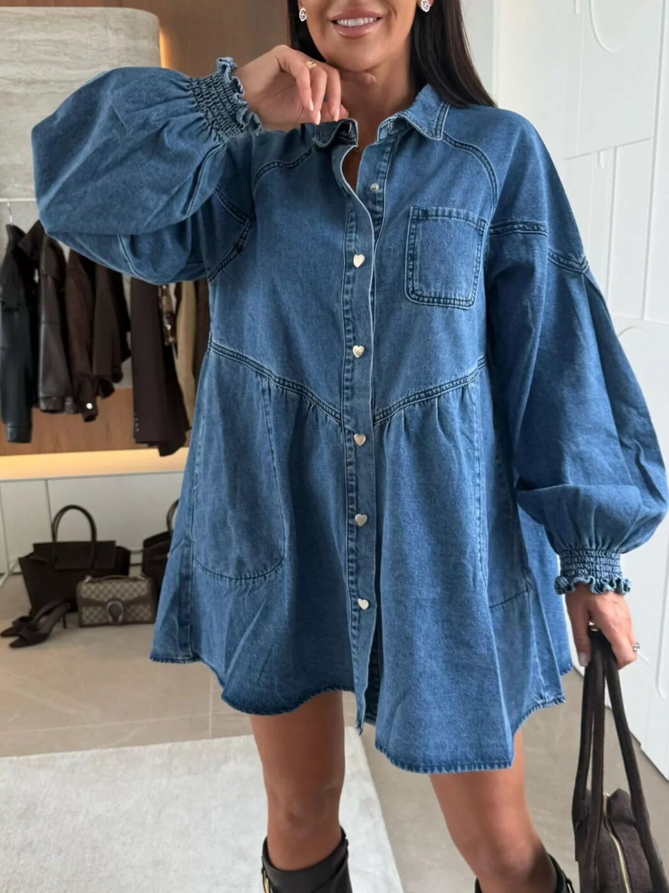 Buttoned denim mini dress with pockets, heart buttons, and smocked cuffs.