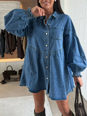 Buttoned denim mini dress with pockets, heart buttons, and smocked cuffs.