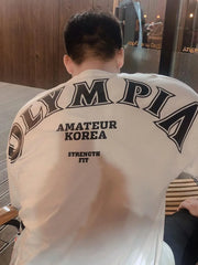 White oversized tee with black Olympia graphic and text print on back
