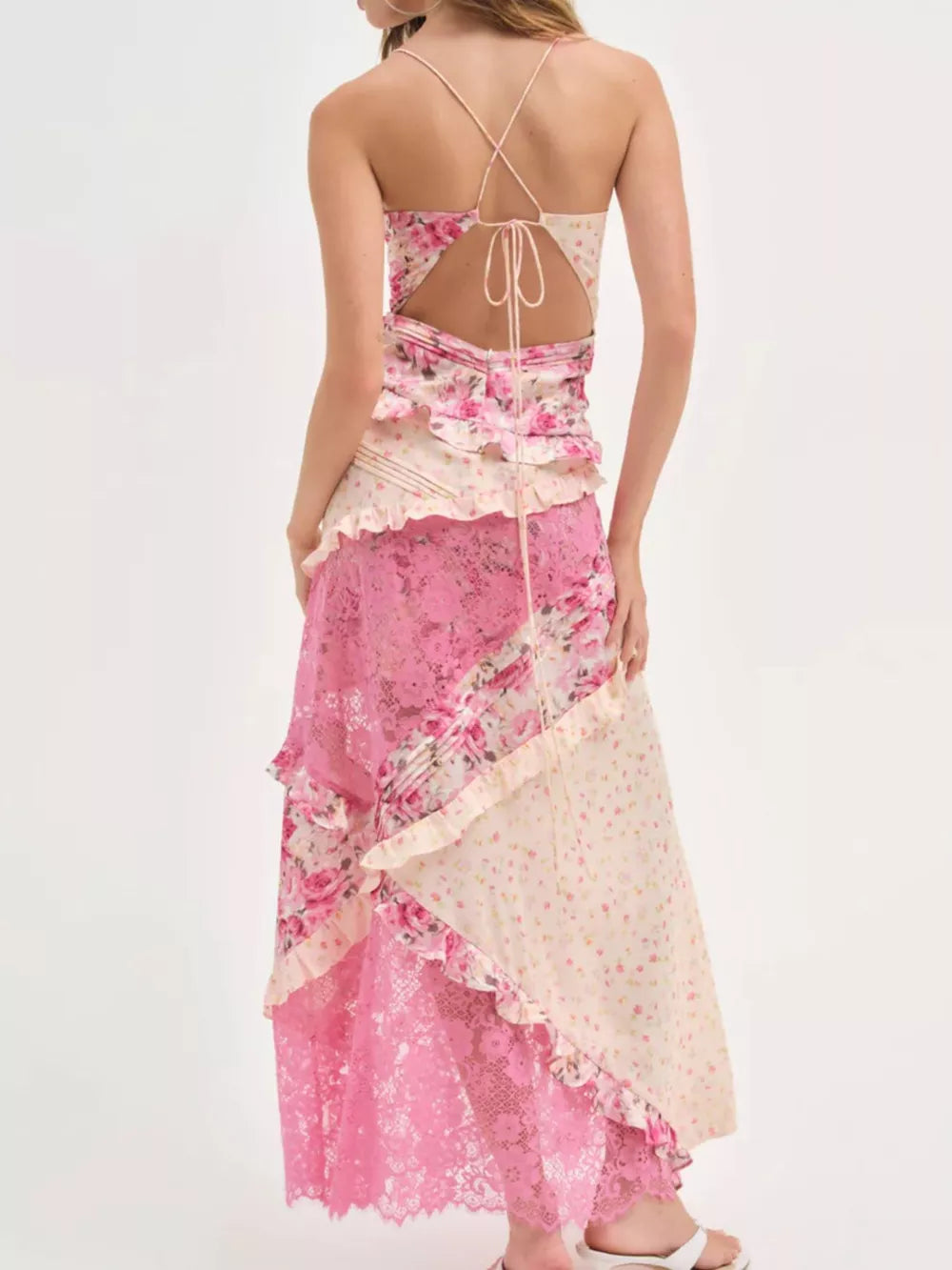 Maxi dress with floral print, lace panels, ruffles, and crisscross back detail.