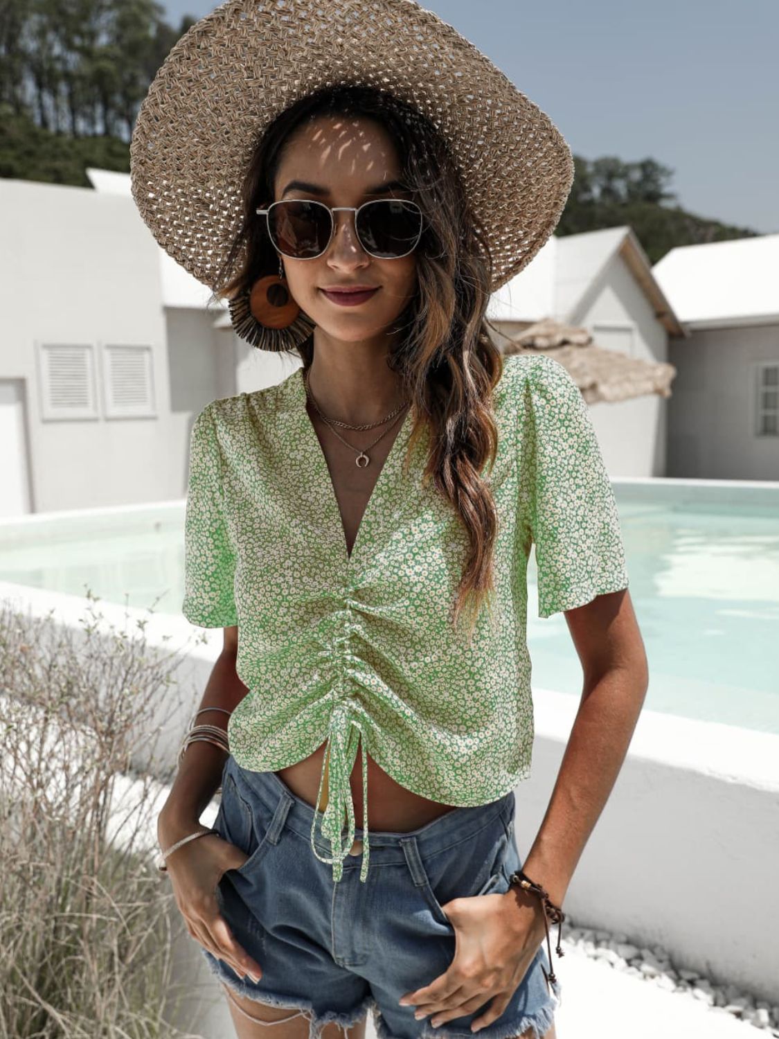 Light green petal print ruched crop top with V-neck and short sleeves.