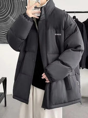 Black oversized quilted puffer jacket with funnel neck and embroidered detail.