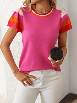 Colorblock knit top with flutter sleeves and striped neckline in hot pink, orange, and white.
