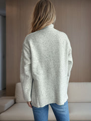 Light grey speckled turtleneck sweater with ribbed hem and side slit detail