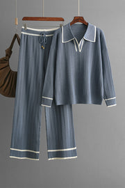 Dusty blue ribbed knit loungewear set with contrast trim, featuring a collared v-neck top and wide-leg pants.