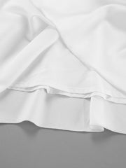 White high-waisted maxi skirt with pockets, showing layered fabric detail.