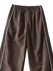 Brown wide-leg maternity trousers with gathered waistband and white side piping