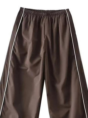 Brown wide-leg maternity trousers with gathered waistband and white side piping