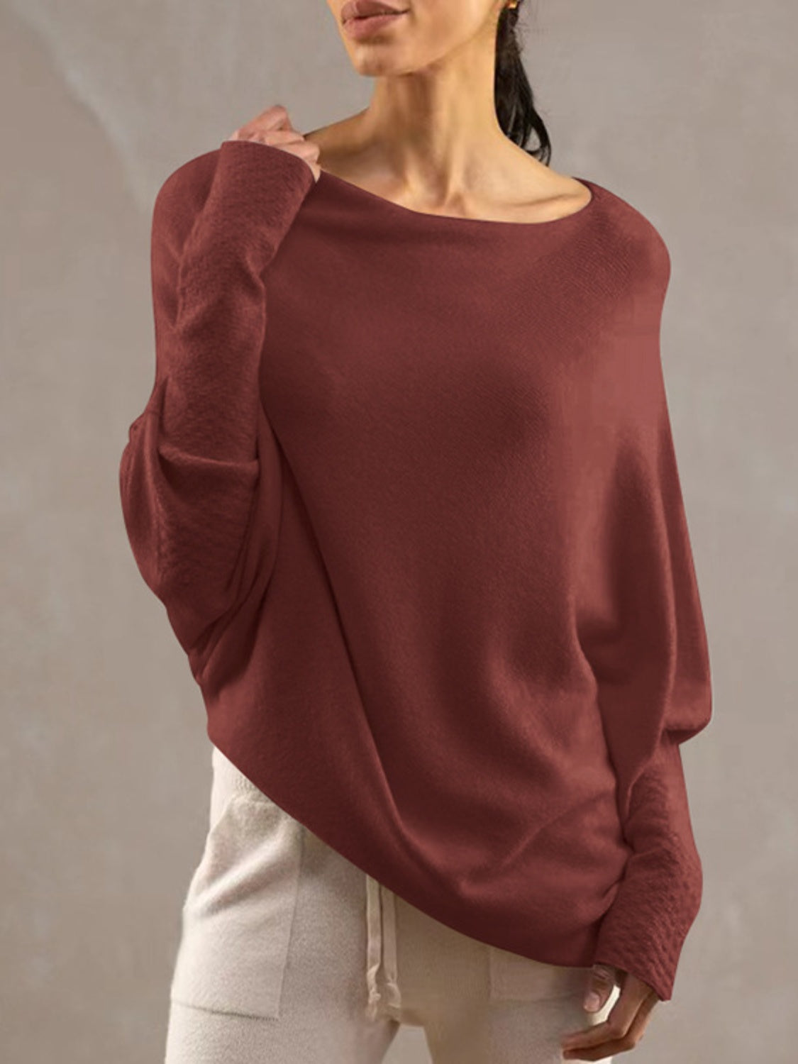 Burgundy off-shoulder knit sweater with textured cuffs and batwing sleeves.