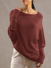 Burgundy off-shoulder knit sweater with textured cuffs and batwing sleeves.