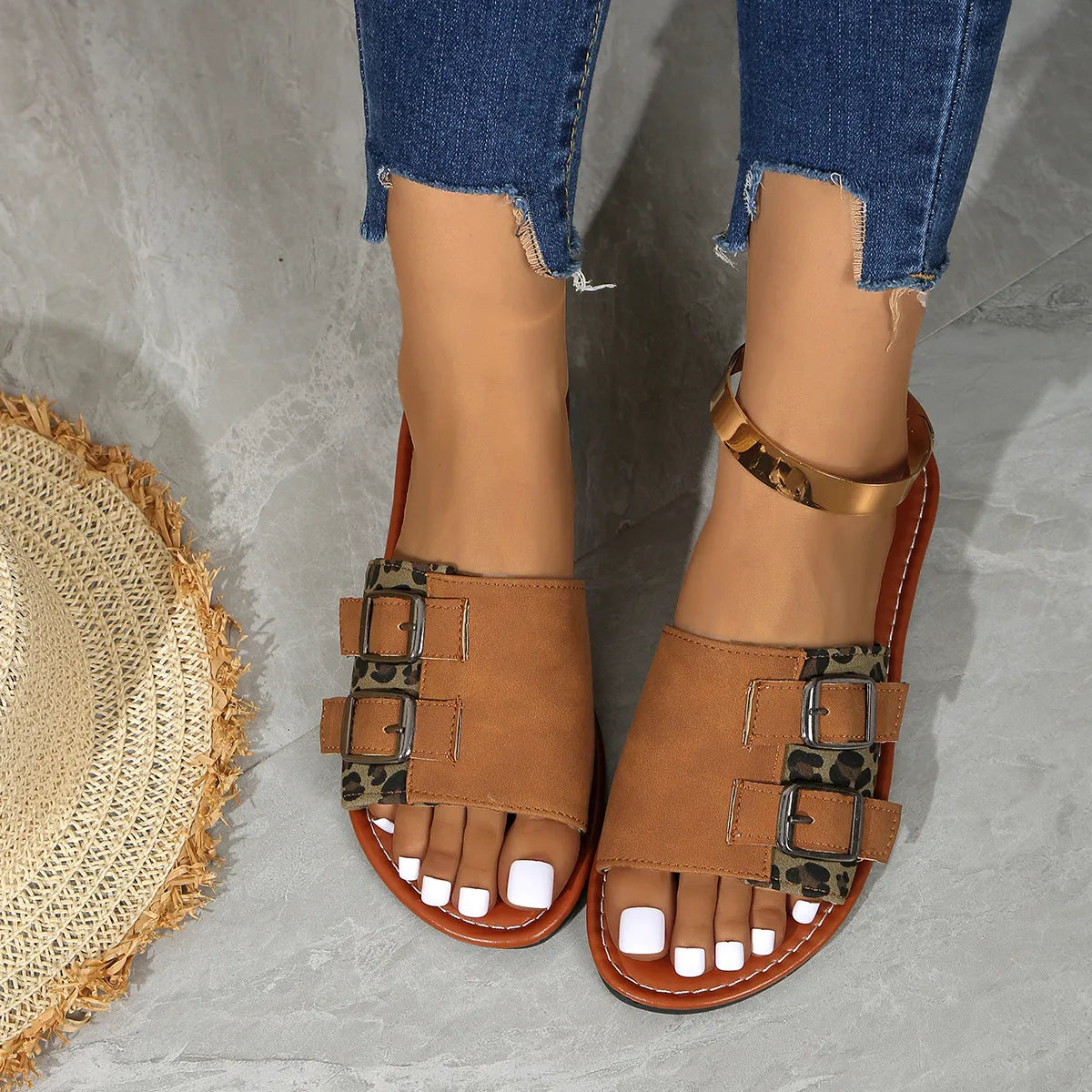 Caramel leopard print sliders with double buckle detail and gold ankle strap.