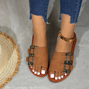 Caramel leopard print sliders with double buckle detail and gold ankle strap.