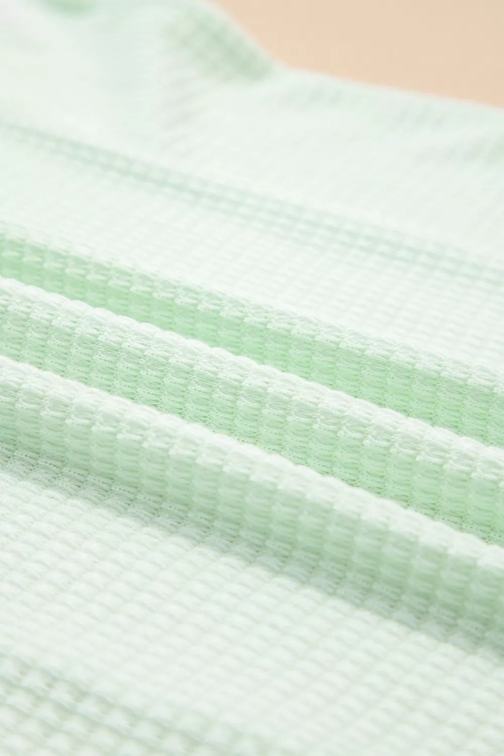 Relaxed V-neck waffle knit t-shirt in light green fabric detail