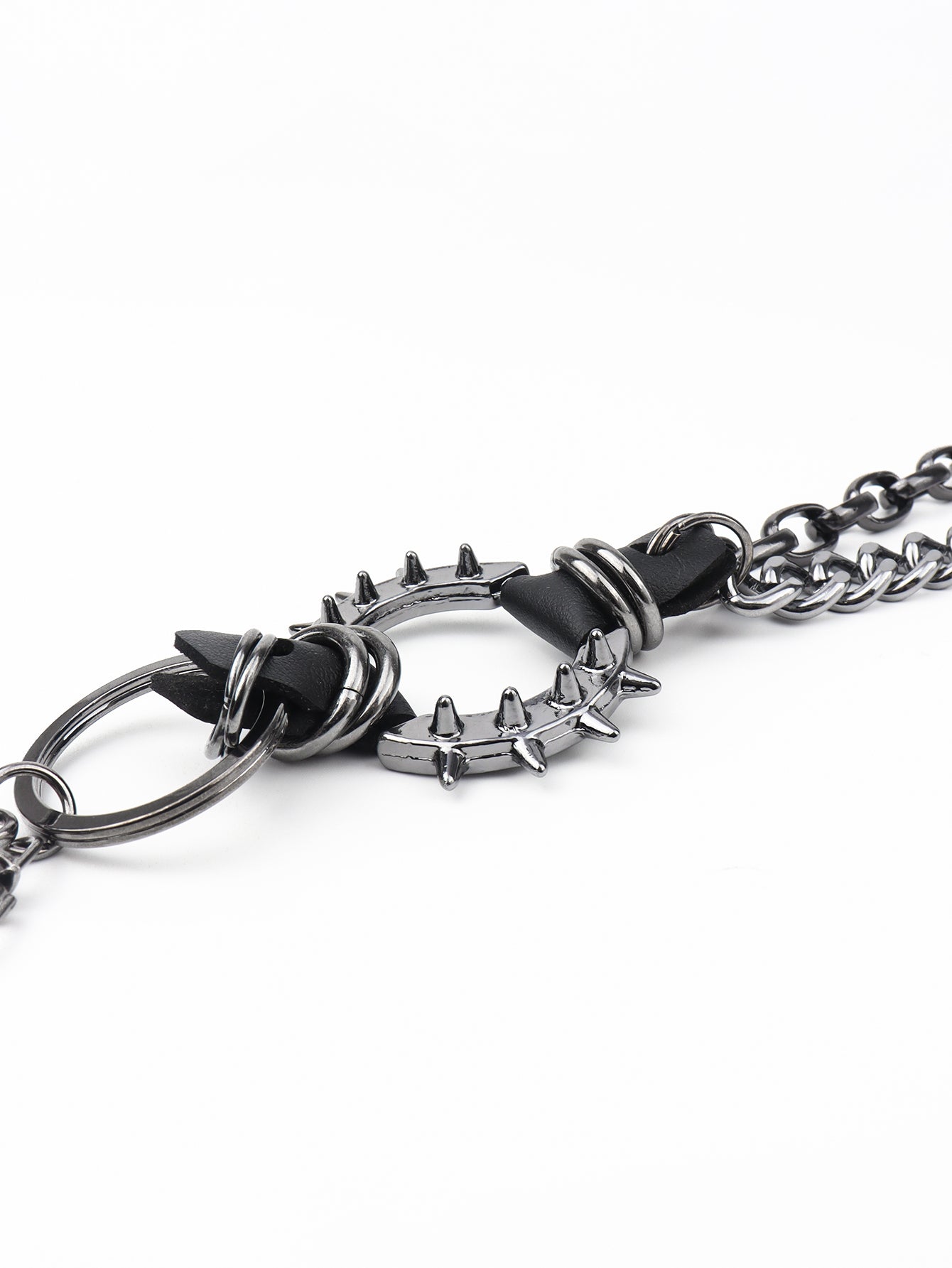 Black spiked chain harness belt with metal ring detail and aluminum spikes.