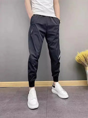 Black cotton sweatpants with ankle cuffs and adjustable drawstring waist.