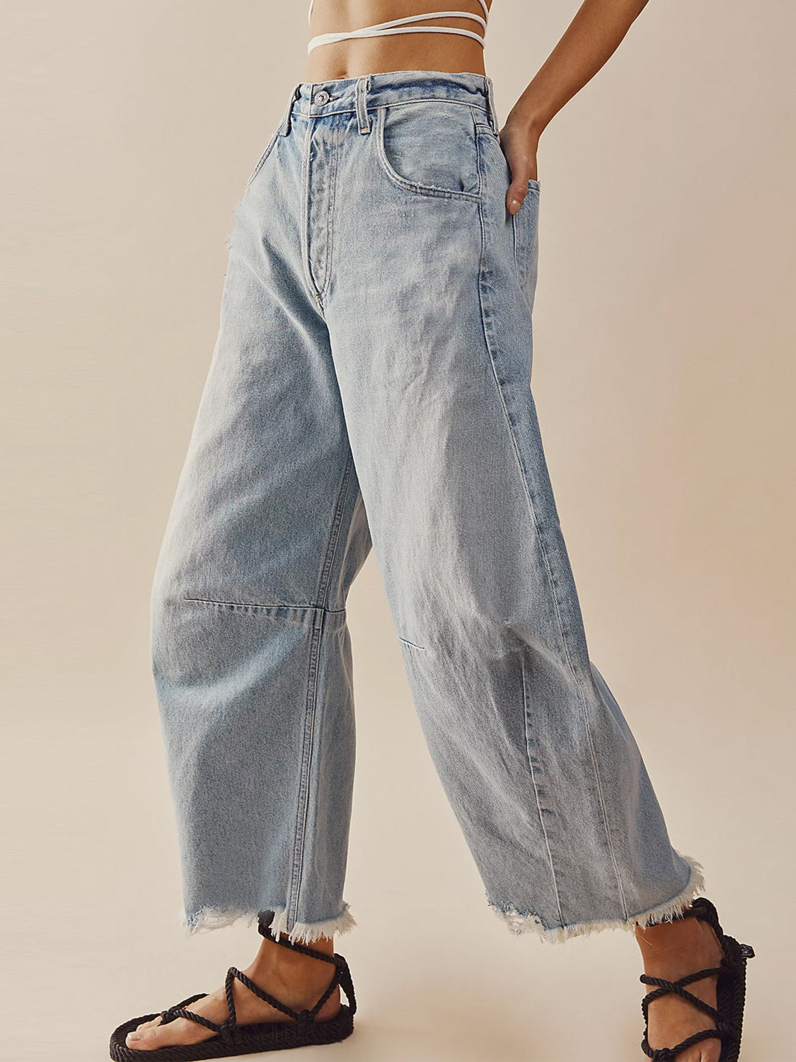 Light wash palazzo jeans with frayed hemline and wide leg