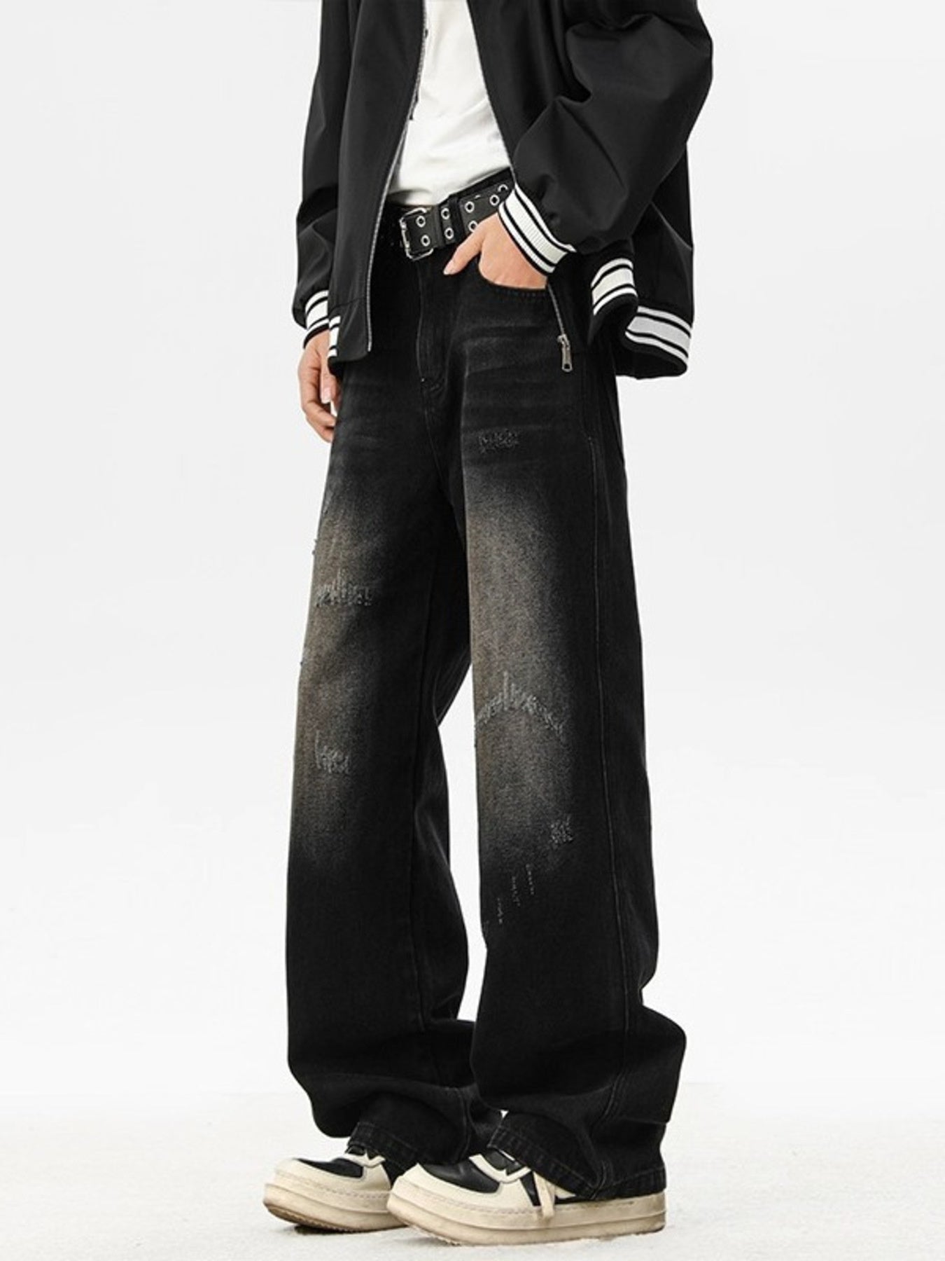 Distressed black wide leg jeans with a faded wash and ripped details.