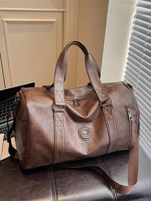 Brown pu leather duffel bag with top handles and a zippered side pocket.