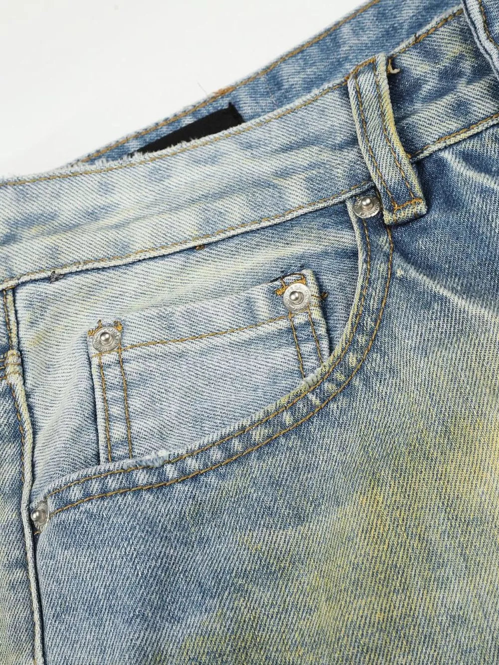 Men's blue wide leg denim jeans with distressed detailing and yellow wash