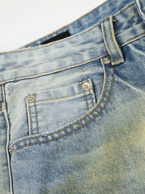 Men's blue wide leg denim jeans with distressed detailing and yellow wash