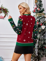Burgundy acrylic knit jumper with festive Christmas tree and snowflake pattern on sleeves and body.