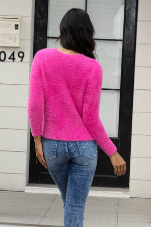 Hot Pink fluffy knit cardigan with crew neck and long sleeves, styled with denim jeans.