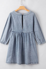 Gathered waist denim mini dress in medium wash with balloon sleeves and a keyhole back detail.