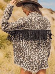 Leopard print denim jacket with collared neck and black fringe embellishment.