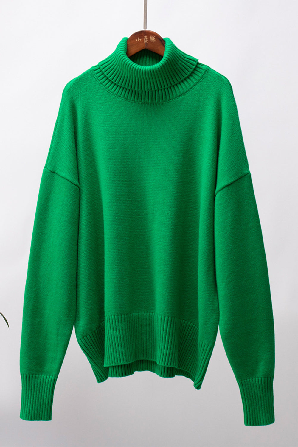 Mid Green relaxed roll-neck sweater with a boxy knit and ribbed cuffs and hem.