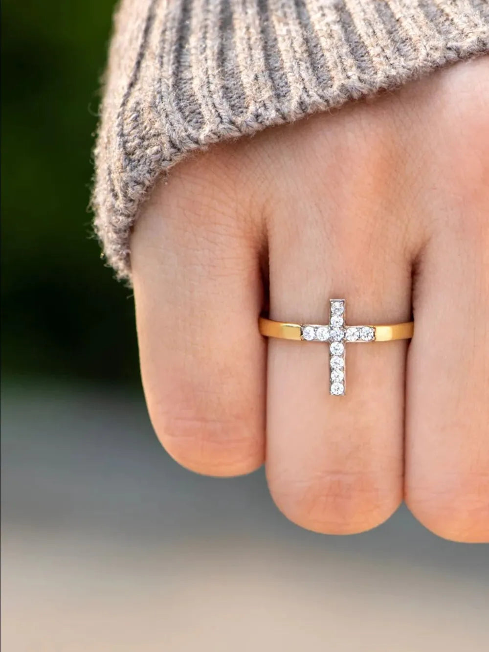 Gold band ring with a pavé crystal cross detail.