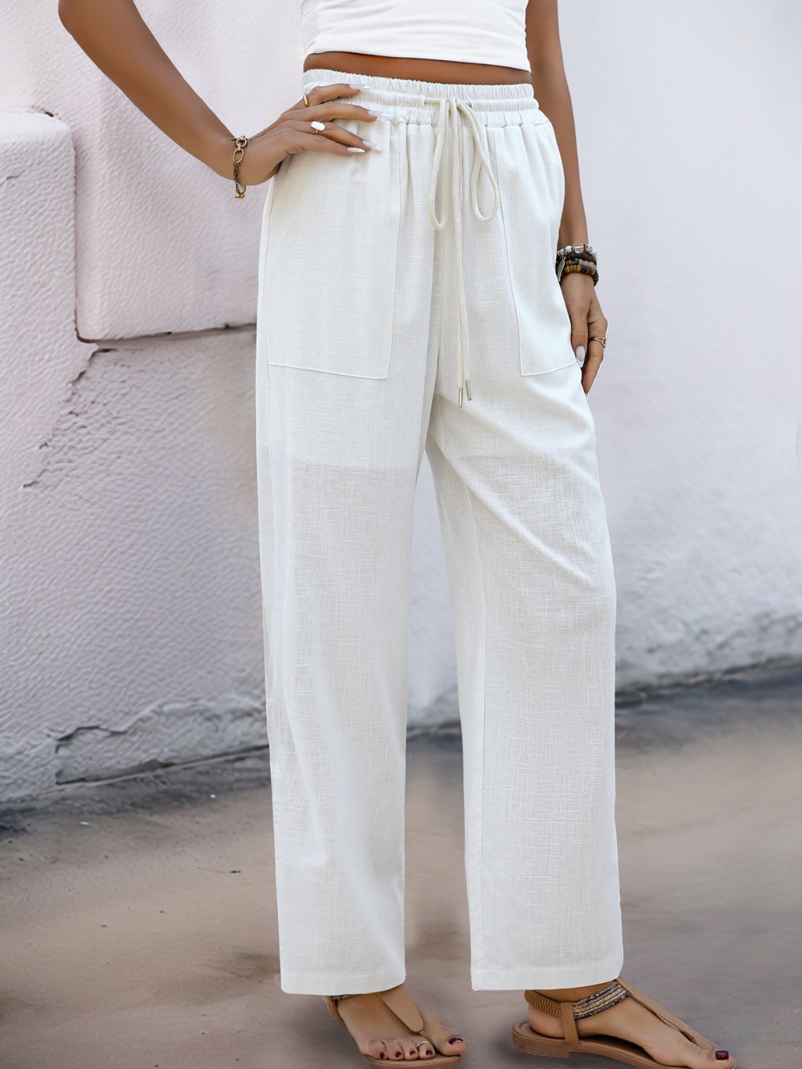 White linen-blend wide-leg trousers with drawstring waist and pockets