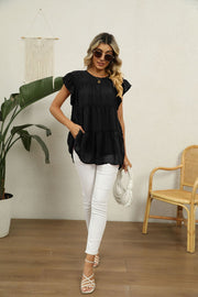 Black Swiss dot tiered flutter sleeve blouse with a round neckline and pockets.
