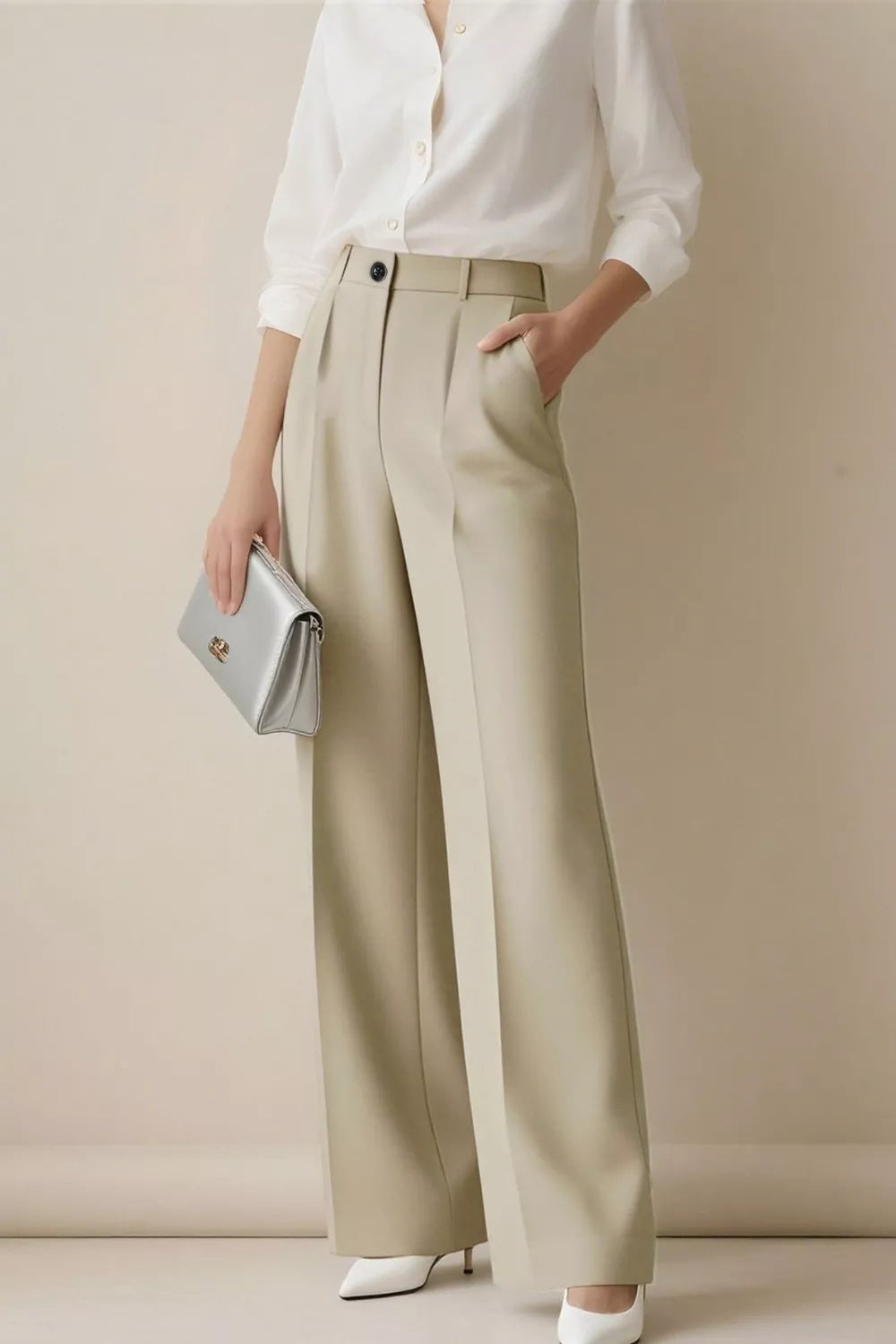 Beige high-waisted wide-leg trousers with pleats and a relaxed fit.
