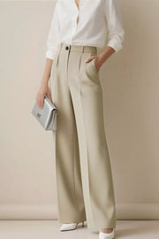 Beige high-waisted wide-leg trousers with pleats and a relaxed fit.