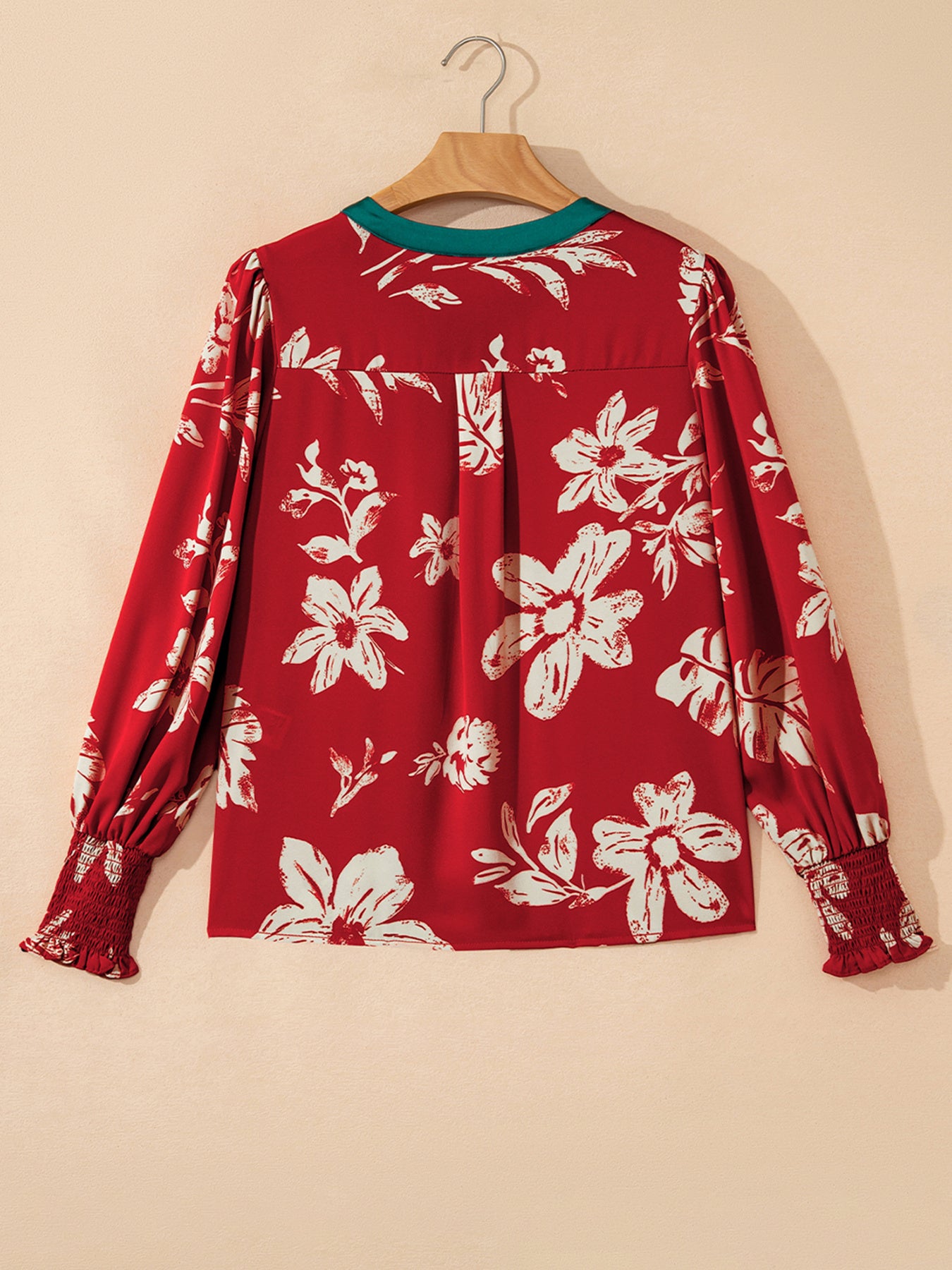 Red floral print blouse with green trim and smocked cuffs