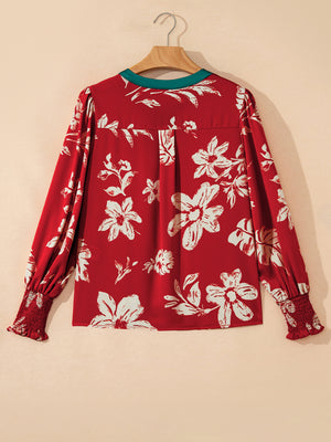 Red floral print blouse with green trim and smocked cuffs