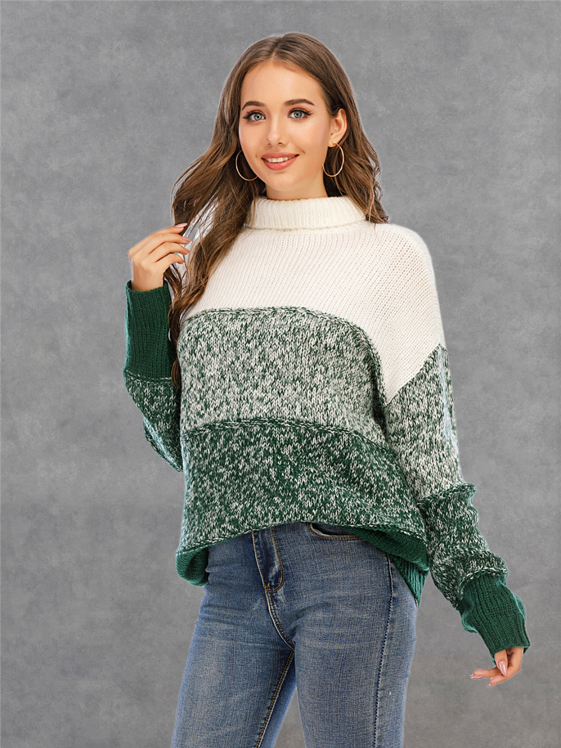 Colorblock knit turtleneck sweater in green and white with defined panels and acrylic material.