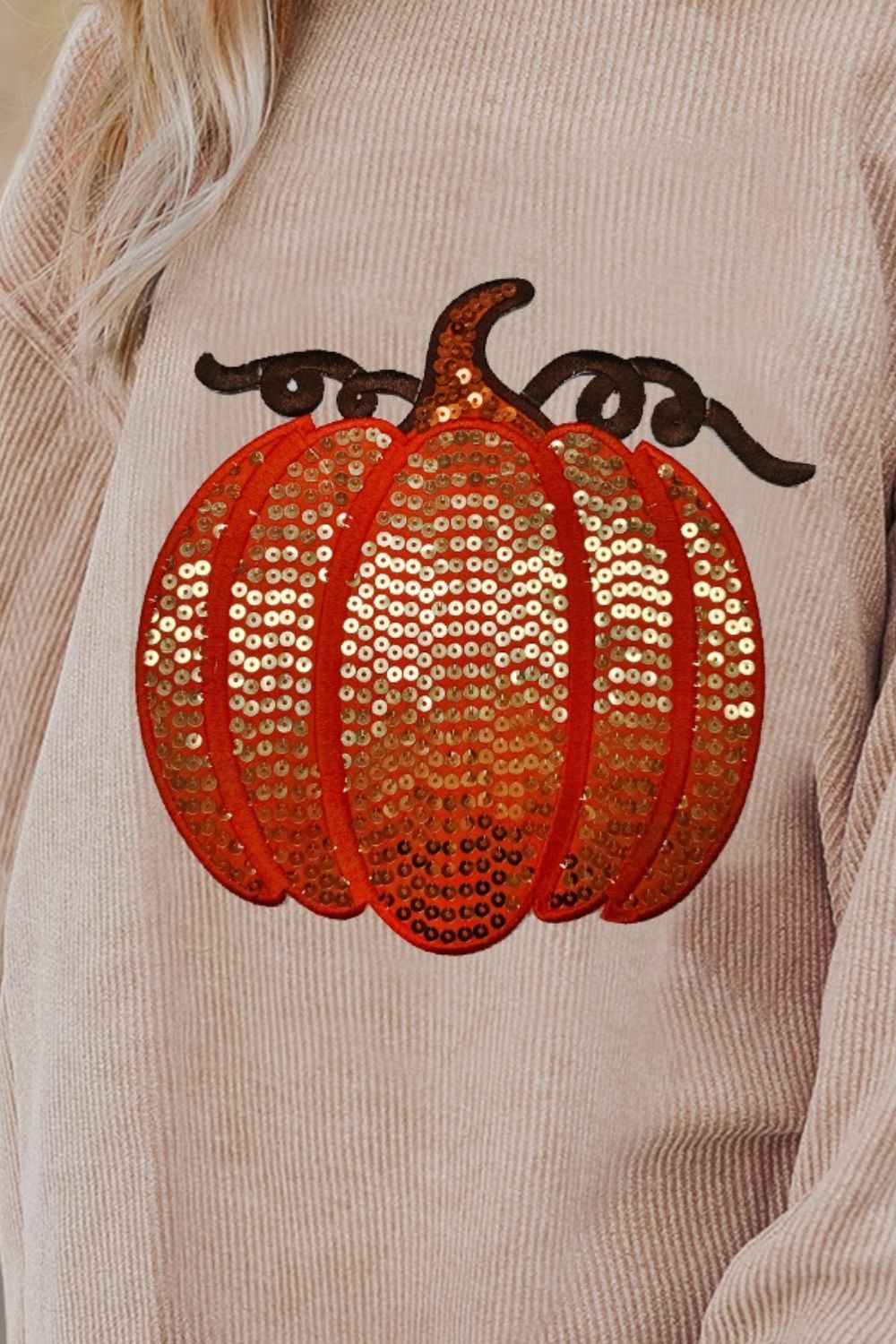 Relaxed fit corduroy sweatshirt in eggshell with a sequin pumpkin detail.