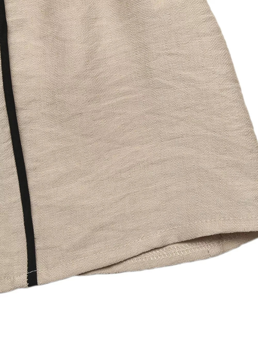 Elegant tied maxi dress in beige linen blend with black piping detail on the side.