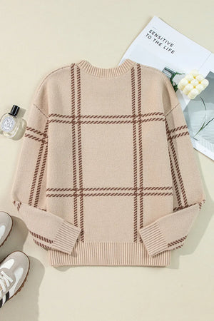Tan crewneck knit pullover sweater with brown plaid pattern and ribbed cuffs and hem.